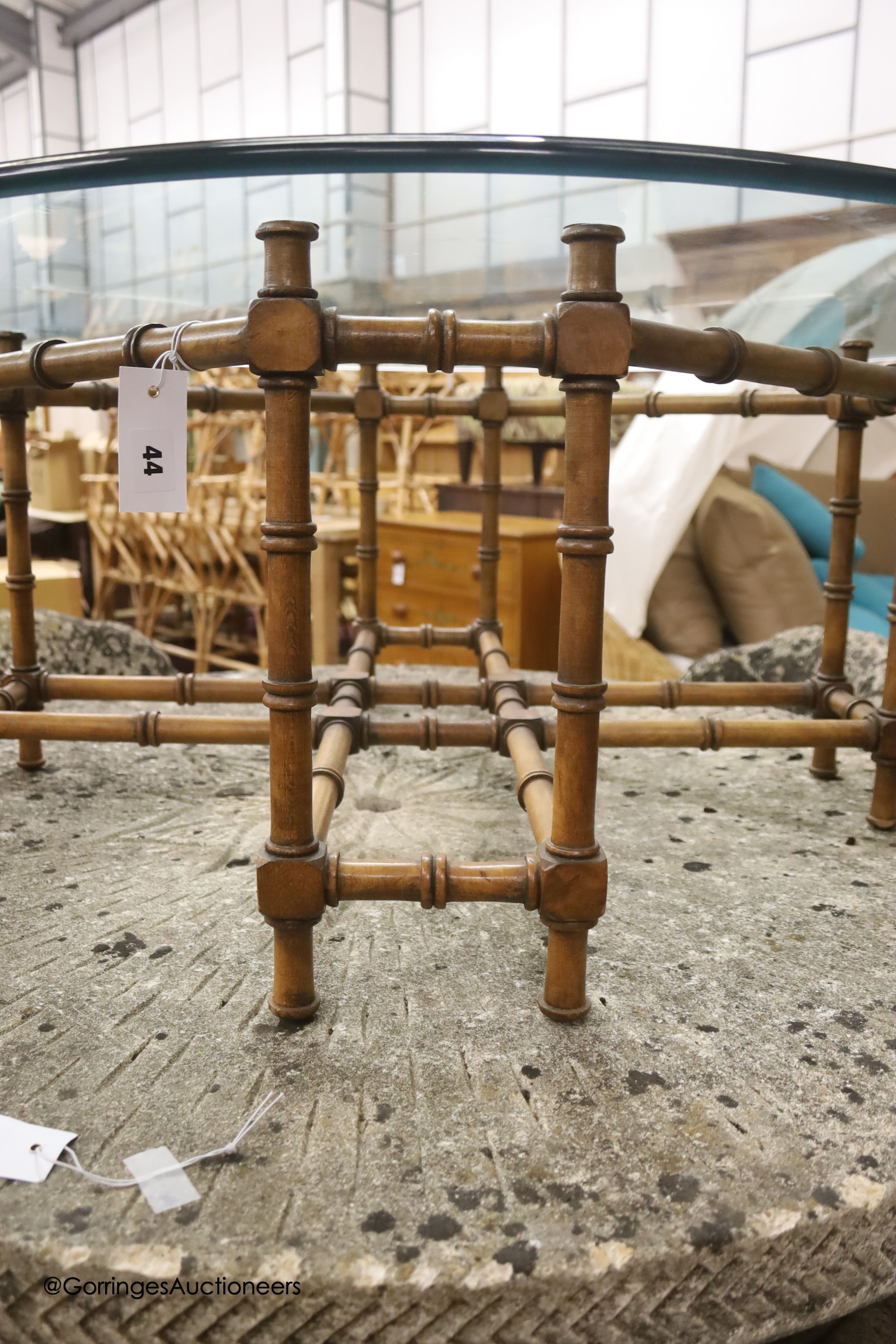 A circular faux bamboo framed glass topped coffee table, diameter 101cm, height 42cm